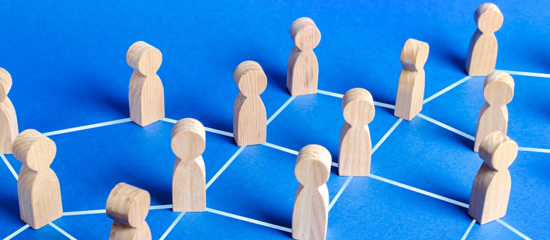 Figures of people connected by lines in a network. Communication and social networks. Cooperation and collaboration. Contact between participants, a team of employees. Society. Spread of information