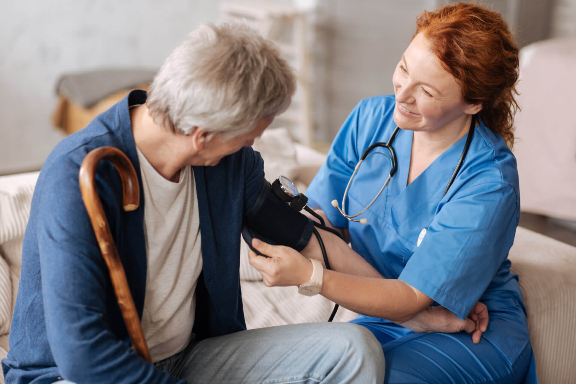 Thoughtful experienced doctor employing tonometer for measurements